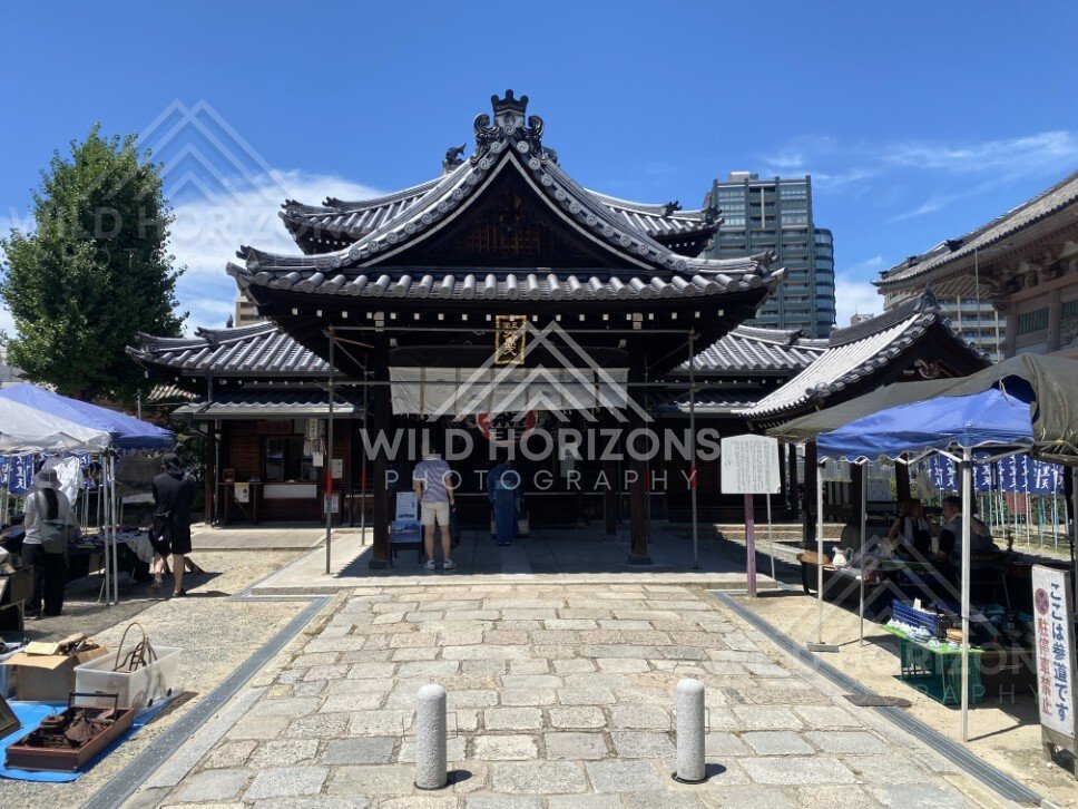 Temple Hall Entrance with Market Stalls and Stone Pathway in the Forecourt. Shitennoji Temple, Osaka, Japan.