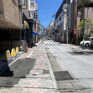 Quiet side street lined with shops and signage in central Hiroshima. Hiroshima, Japan.