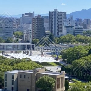 Close city view over treetops and modern buildings in Hiroshima. Hiroshima, Japan.