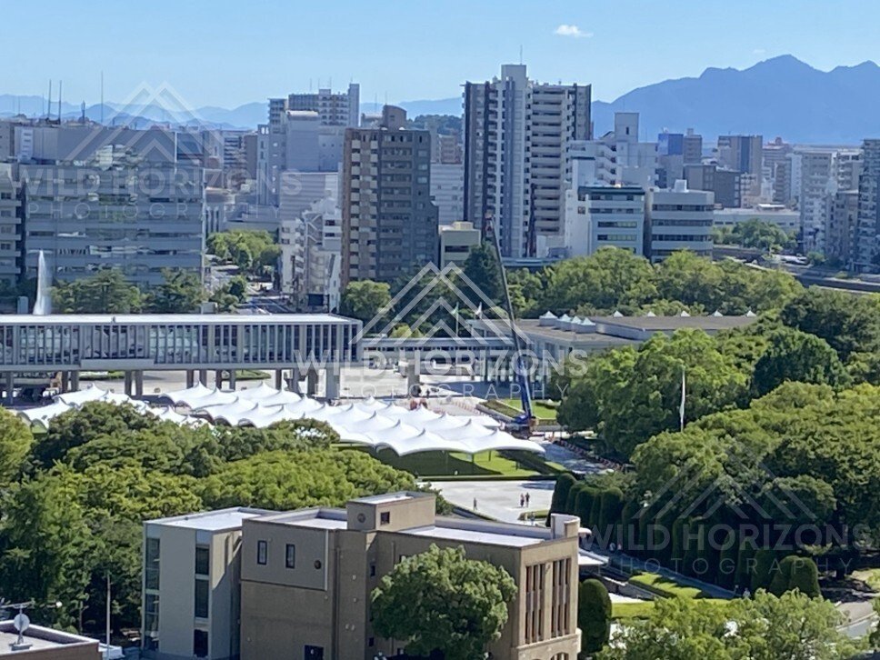 Close city view over treetops and modern buildings in Hiroshima. Hiroshima, Japan.