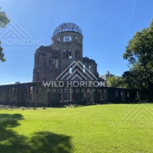 Wide view of the Atomic Bomb Dome framed by trees and open lawn. Hiroshima Peace Memorial, Hiroshima, Japan.
