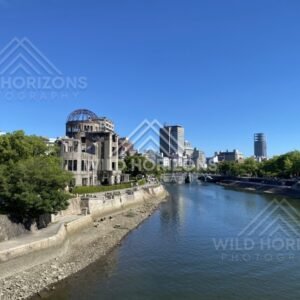 Wide river view with the Atomic Bomb Dome and Hiroshima skyline beyond. Hiroshima, Japan.