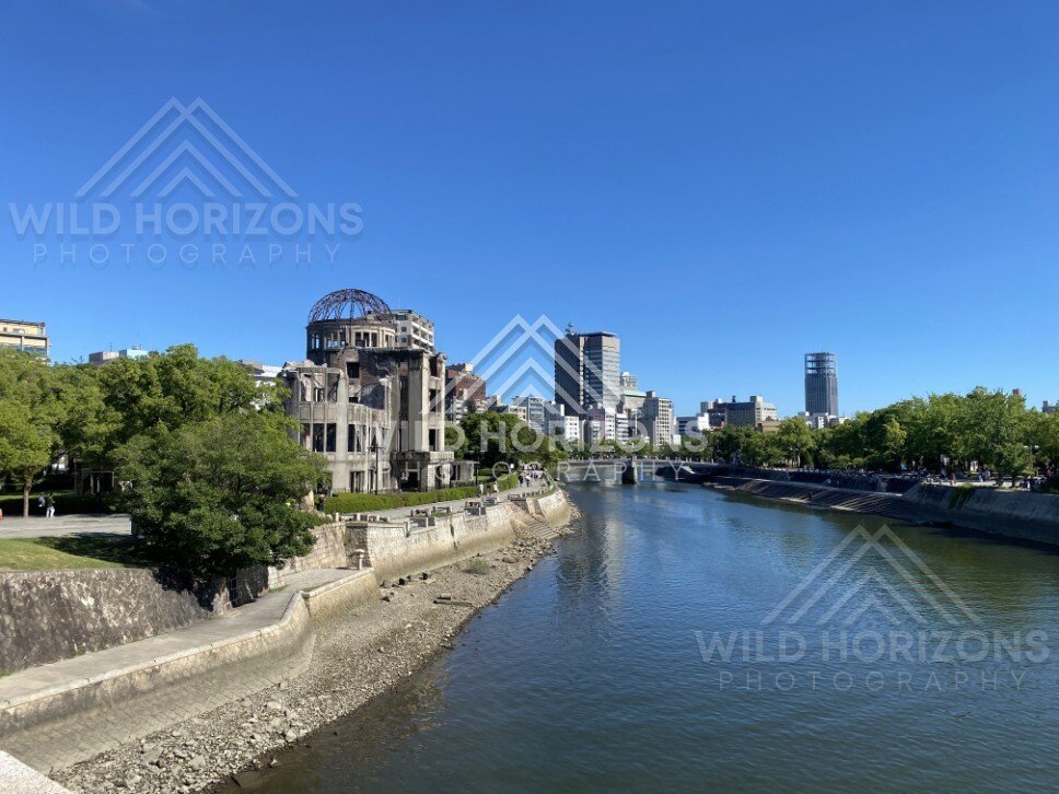 Wide river view with the Atomic Bomb Dome and Hiroshima skyline beyond. Hiroshima, Japan.