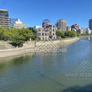 River corridor with the Atomic Bomb Dome and embankments in bright daylight. Hiroshima, Japan.