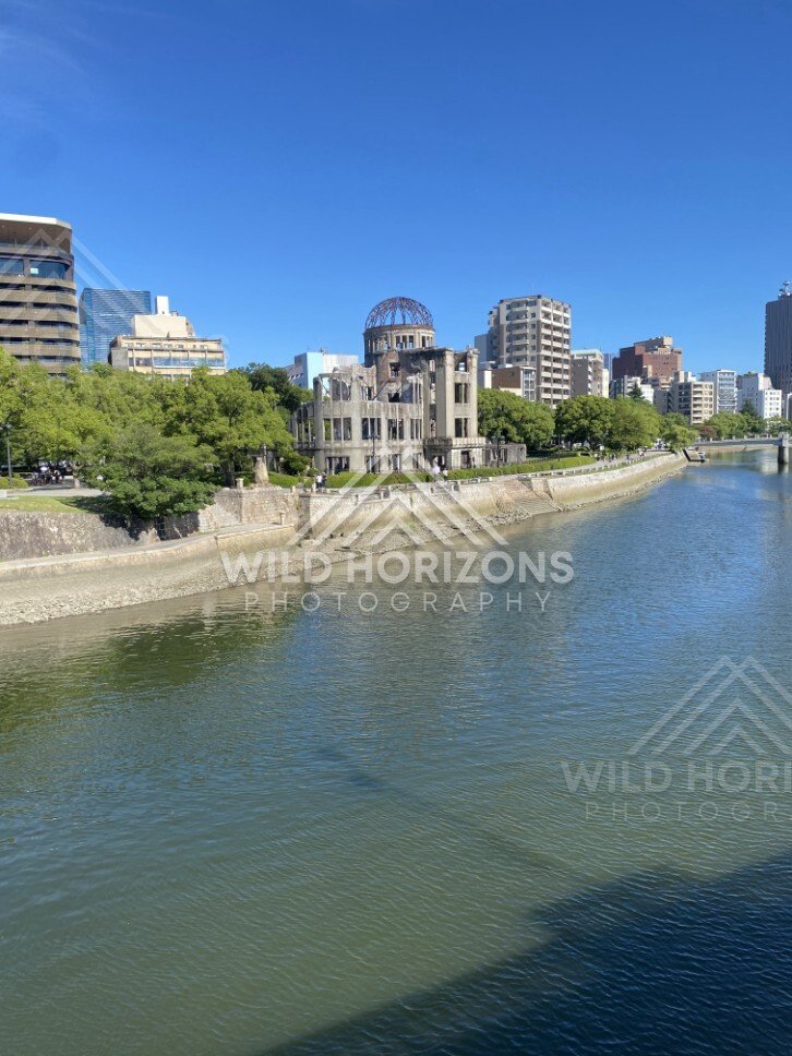 River corridor with the Atomic Bomb Dome and embankments in bright daylight. Hiroshima, Japan.
