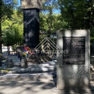 Stone memorial monument beneath trees in Hiroshima Peace Memorial Park. Hiroshima Peace Memorial Park, Hiroshima, Japan.