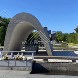 Curved concrete memorial arch overlooking the Peace Memorial grounds. Hiroshima Peace Memorial Park, Hiroshima, Japan.
