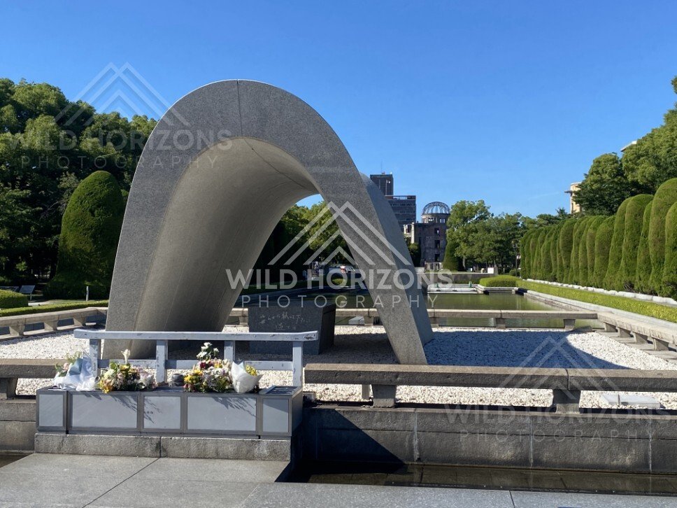 Curved concrete memorial arch overlooking the Peace Memorial grounds. Hiroshima Peace Memorial Park, Hiroshima, Japan.
