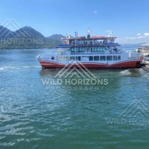 Passenger ferry docked at the waterfront on Miyajima Island. Miyajima, Hiroshima, Japan.