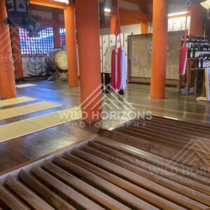 Interior view of a shrine hall with drums and ritual objects. Miyajima, Hiroshima, Japan.