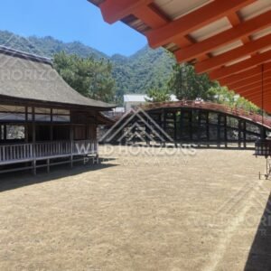 Traditional wooden buildings and arched bridge within the shrine grounds. Miyajima, Hiroshima, Japan.