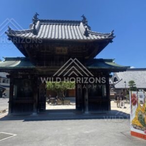 Traditional temple gate marking the entrance to a historic precinct. Miyajima, Hiroshima, Japan.
