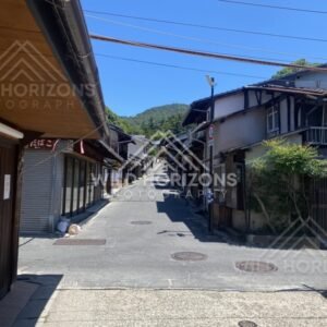 Quiet narrow street lined with traditional buildings in the village. Miyajima, Hiroshima, Japan.