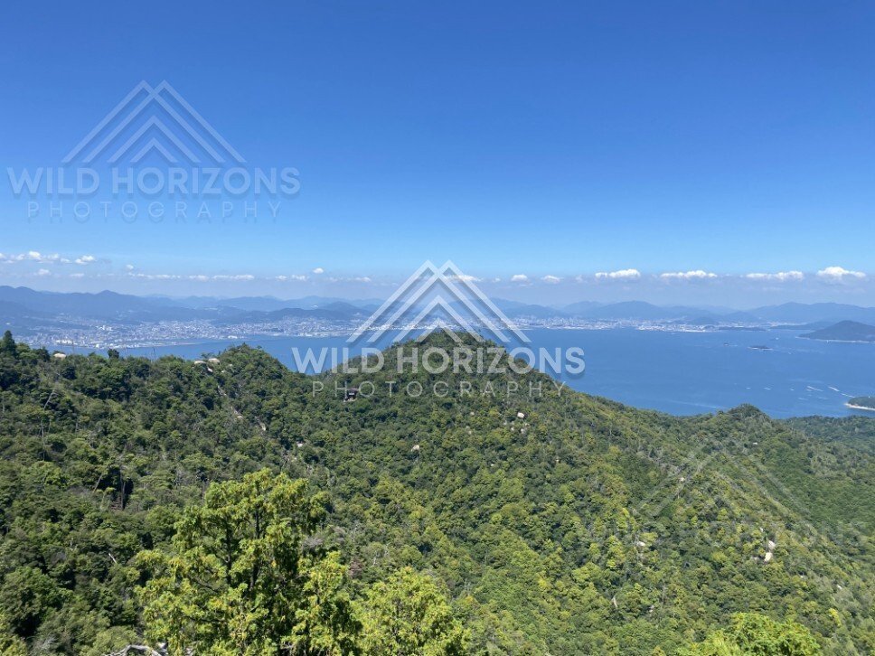 Sweeping coastal panorama from a high mountain lookout over Miyajima. Miyajima, Hiroshima, Japan.