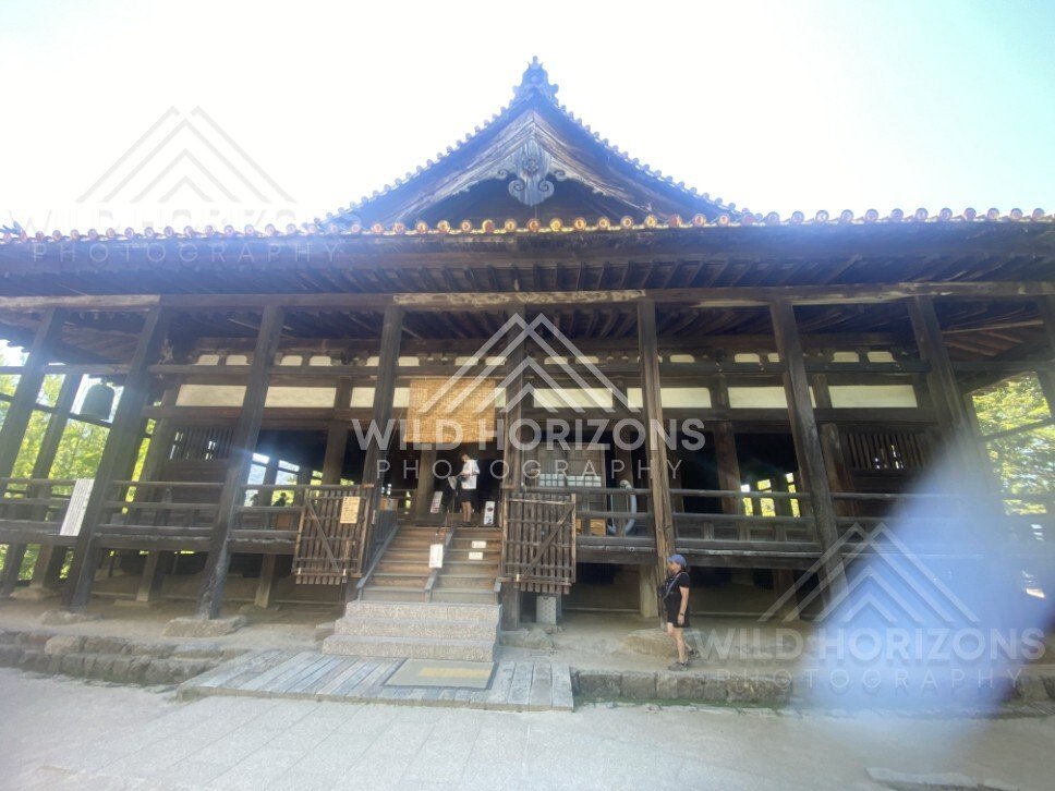 Wooden temple hall with tiled roof and raised veranda. Miyajima, Hiroshima, Japan.