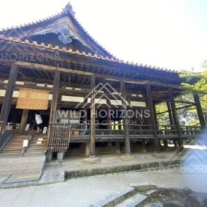 Side view of traditional temple hall with raised wooden platform. Miyajima, Hiroshima, Japan.