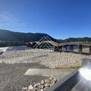 Wide riverbed view with Kintaikyo Bridge in the distance. Iwakuni, Yamaguchi, Japan.