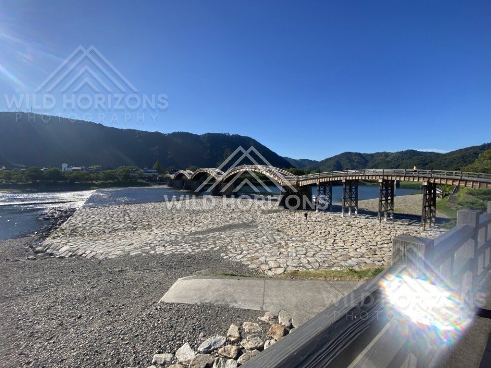 Wide riverbed view with Kintaikyo Bridge in the distance. Iwakuni, Yamaguchi, Japan.