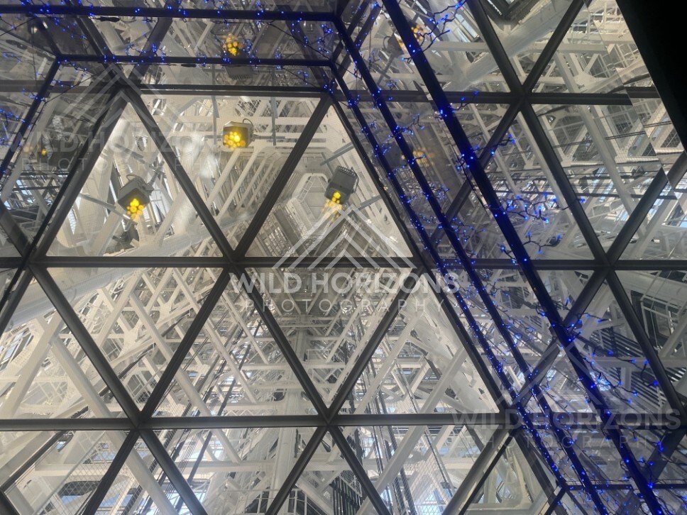 Interior view of geometric glass ceiling with structural framework. Fukuoka, Japan.