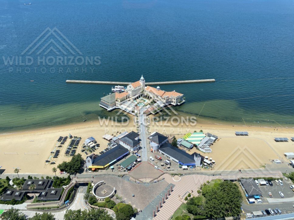 Aerial view of pier complex and beachfront with surrounding facilities. Fukuoka, Japan.