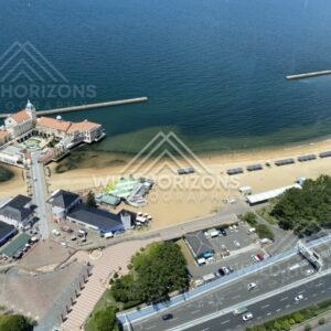 High-angle view of pier building, beach, and coastal road. Fukuoka, Japan.