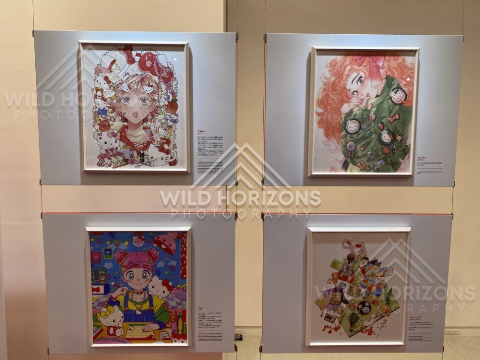 Framed Hello Kitty inspired illustrations are arranged on a gallery wall in an exhibition. Fukuoka, Japan.