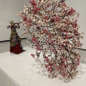 Art installation of a blossoming tree sculpture with a figure looking through a telescope. Fukuoka, Japan.