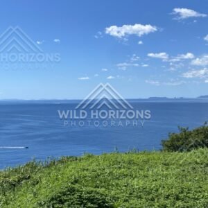 Ocean horizon and distant islands seen from a grassy headland. Nagasaki, Japan.