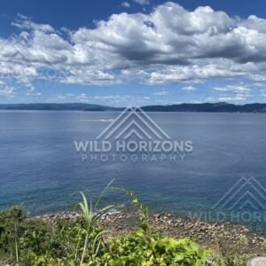 Rocky coast and open sea under dramatic cumulus clouds. Nagasaki, Japan.