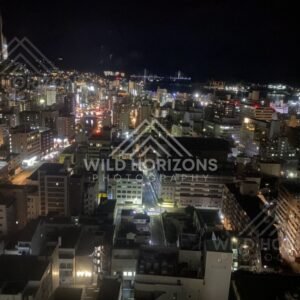 Night city skyline with harbour lights viewed from a high observation point. Nagasaki, Japan.