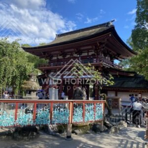Vermilion Shrine Gate with Visitors at Dazaifu Tenmangu. Dazaifu, Japan.