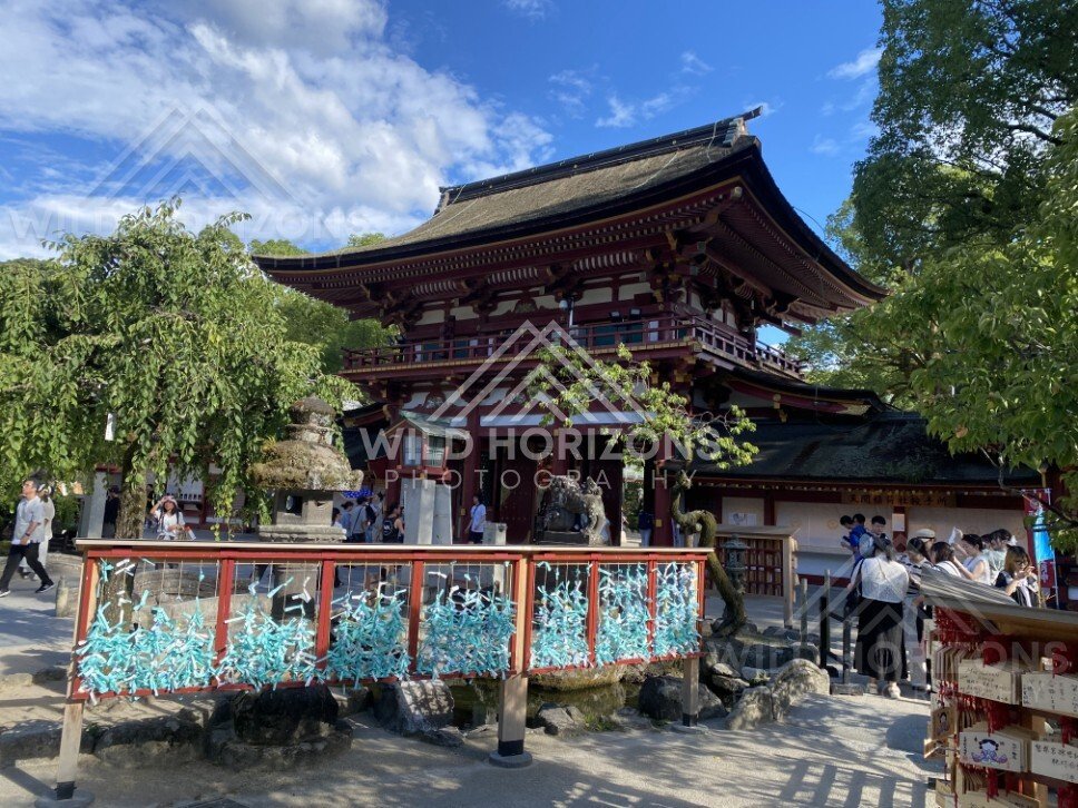 Vermilion Shrine Gate with Visitors at Dazaifu Tenmangu. Dazaifu, Japan.