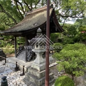 Stone Lanterns and Thatched Roof Shrine Pavilion in a Garden Setting. Fukuoka, Japan.