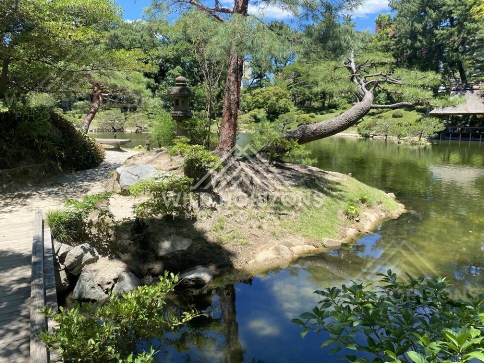 Garden Path and Stone Lantern Beside the Pond. Hiroshima, Japan.