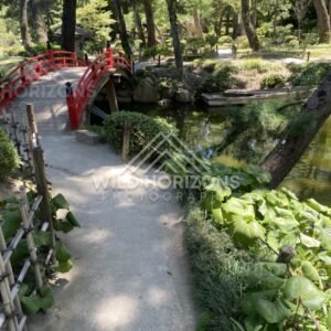 Red Arched Bridge Crossing a Garden Pond. Hiroshima, Japan.