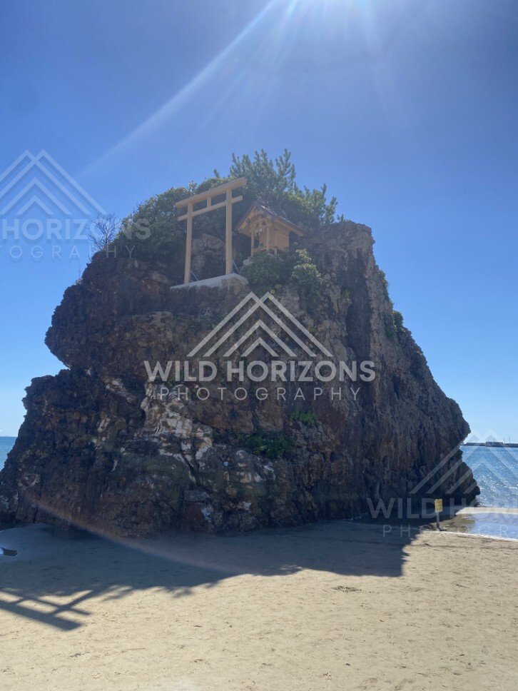 Benten-jima Rock Island with Shrine and Sun Flare. Izumo, Japan.