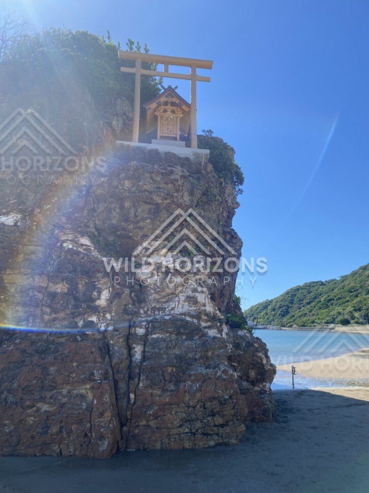 Torii Gate and Small Shrine Perched on a Sea Cliff. Izumo, Japan.