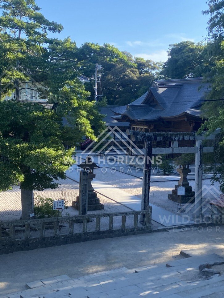 Quiet Shrine Courtyard with Torii and Stone Lanterns. Matsue, Japan.