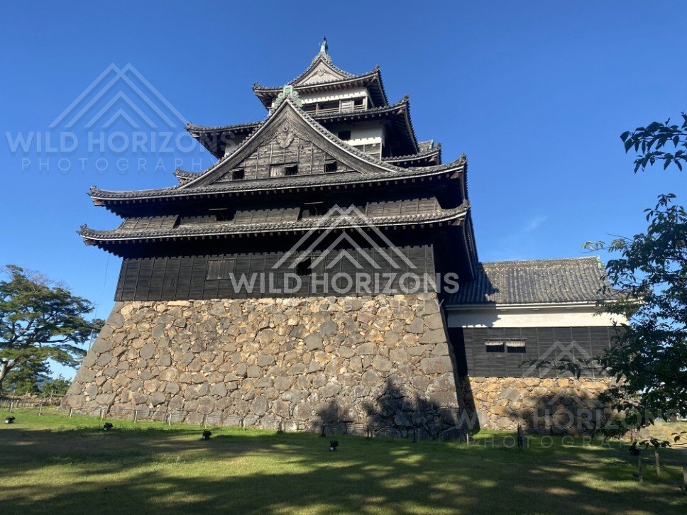 Matsue Castle Keep with Adjacent Rooflines and Lawn. Matsue, Japan.