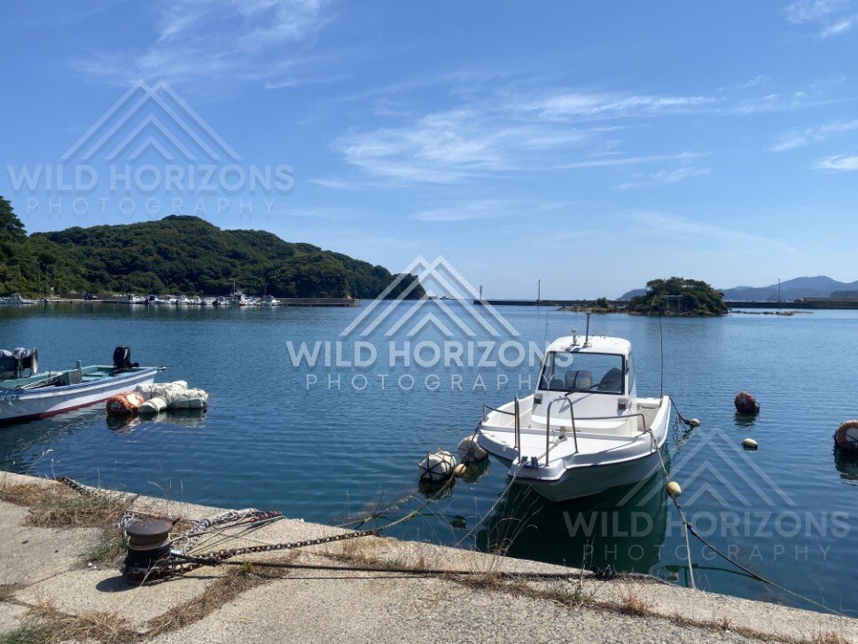 Small Fishing Boat Moored in a Calm Harbor Lagoon. Shimane, Japan.