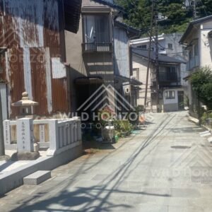 Quiet Street With Corrugated Buildings and Stone Lantern Marker. Mihonoseki, Japan.