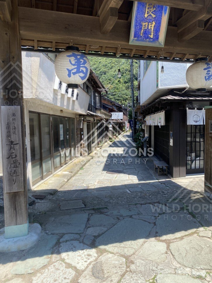 Lantern Gate Framing a Traditional Stone-Paved Street. Mihonoseki, Japan.