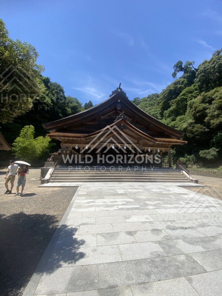 Wide View of Miho Shrine Hall and Open Courtyard Under Blue Sky. Mihonoseki, Japan.