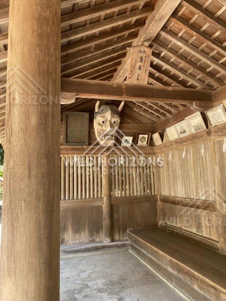 Wooden Shelter Displaying a Traditional Oni Mask. Mihonoseki, Japan.