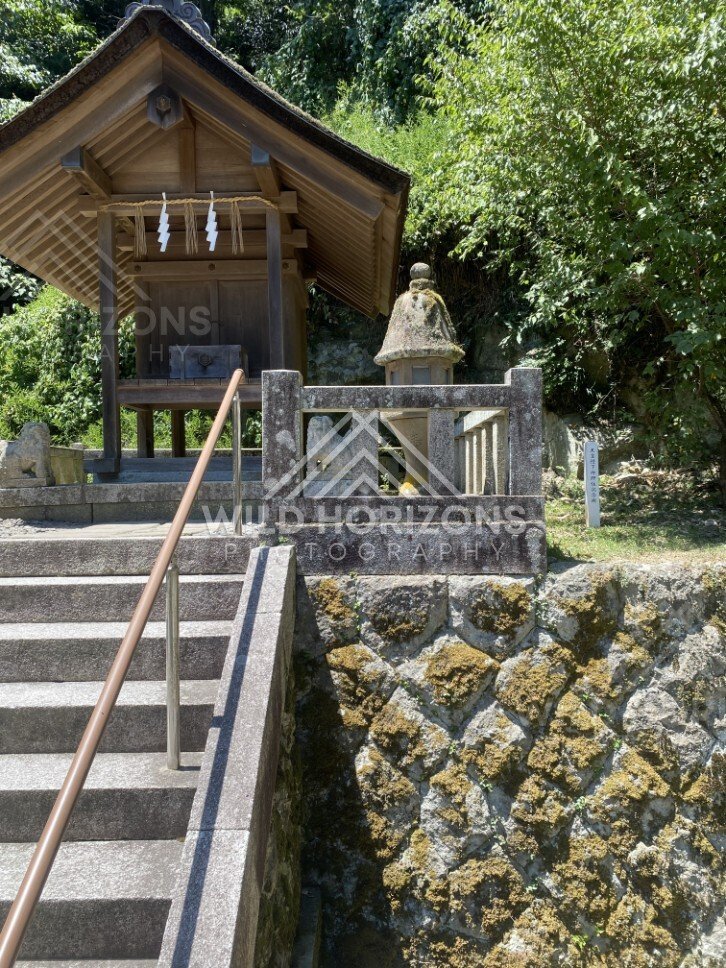 Small Hillside Shrine Above a Mossy Stone Retaining Wall. Mihonoseki, Japan.