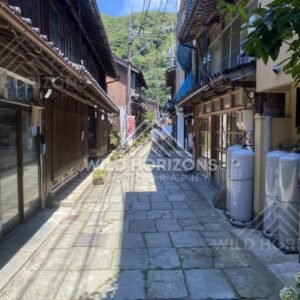 Narrow Stone-Paved Lane Between Traditional Wooden Buildings. Mihonoseki, Japan.