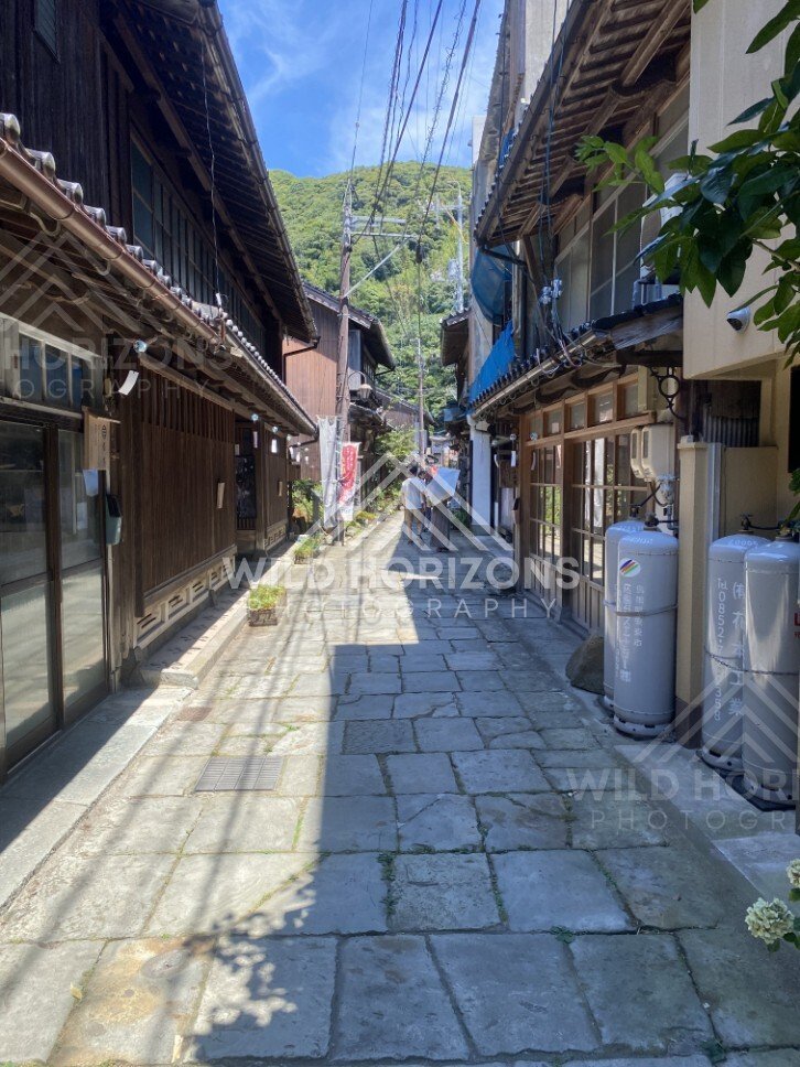 Narrow Stone-Paved Lane Between Traditional Wooden Buildings. Mihonoseki, Japan.