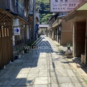 Old Town Street With Japanese Signage and Sunlit Stone Paving. Mihonoseki, Japan.