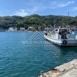 Fishing Boat Moored in a Calm Harbour With Green Hills Beyond. Mihonoseki, Japan.