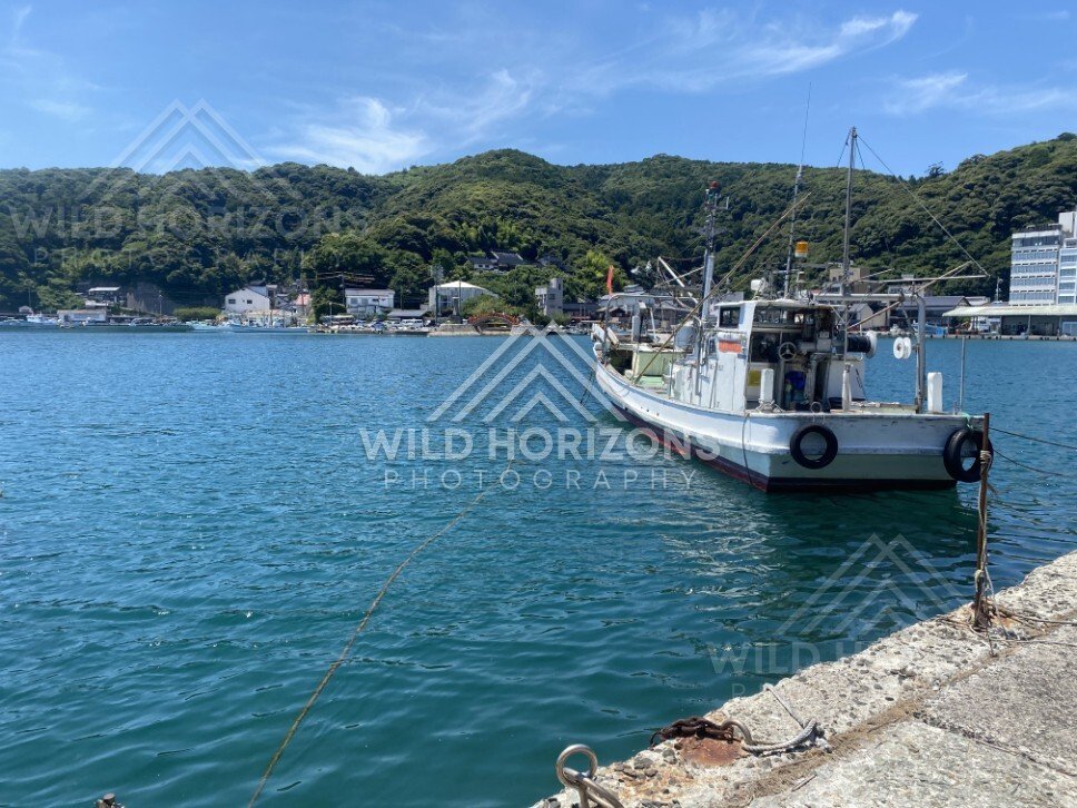 Fishing Boat Moored in a Calm Harbour With Green Hills Beyond. Mihonoseki, Japan.